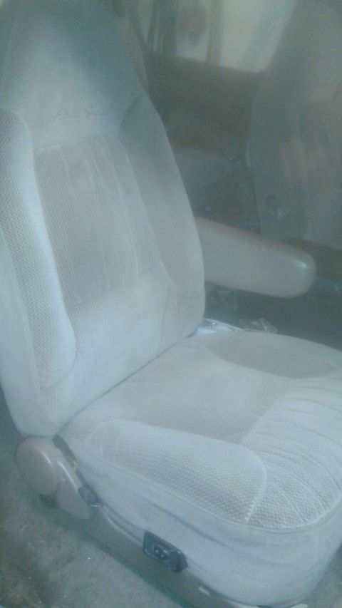 1996 Ford Bronco - Interior view of a 1996 Ford Bronco driver's seat with light tan fabric upholstery.