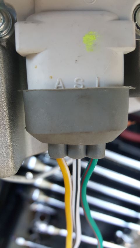 1978 Ford Bronco - This image shows a close-up of an electrical connector with three wires: yellow, white, and green. Text 'ASI' is visible on the connector h…