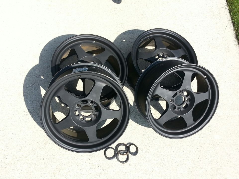 Set of four dark gray alloy wheels with five spokes and a center cap