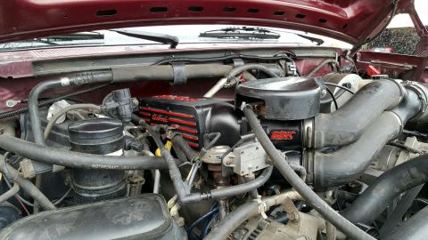 1996 Ford Bronco - Close-up of an engine bay an Edelbrock intake manifold, with a Supermotors.net logo visible at the bottom right.