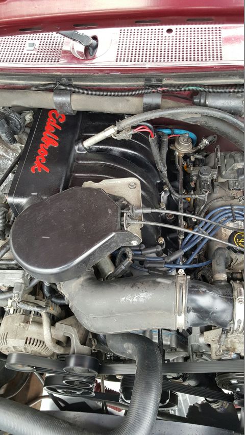 1996 Ford Bronco - Close-up of a Ford engine, highlighting the Edelbrock intake manifold and associated components.