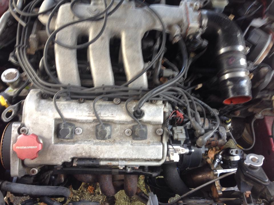 Close-up of a Mazda engine with a red Mazdaspeed oil cap.