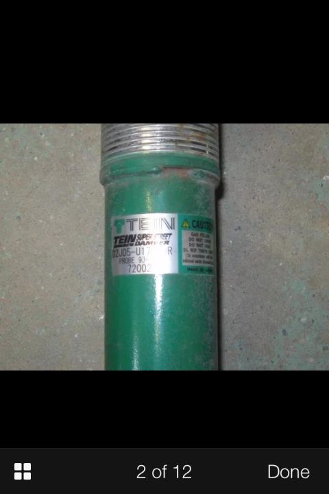 1995 Ford Probe - A close-up of a green TEIN SUPER STREET DAMPER with a label showing part number 02J05-U17R and probe 93-72002. The damper is threaded at th…