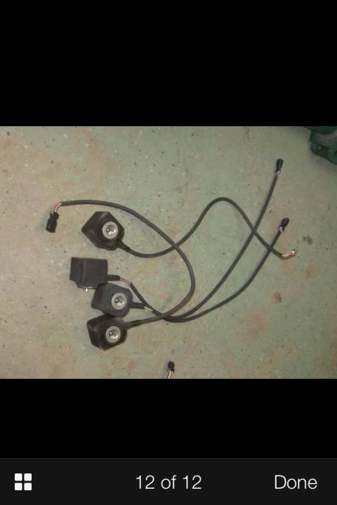 1995 Ford Probe - A collection of black electrical components with wires and connectors are laid out on a speckled concrete floor.