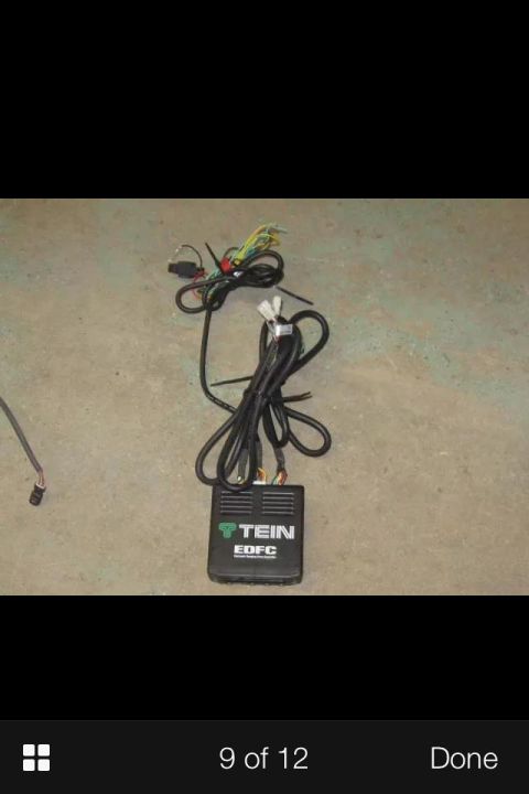 1995 Ford Probe - A black TEIN EDFC controller unit with multiple wiring harnesses is laid out on a concrete surface. The unit has a green TEIN logo and "EDF…