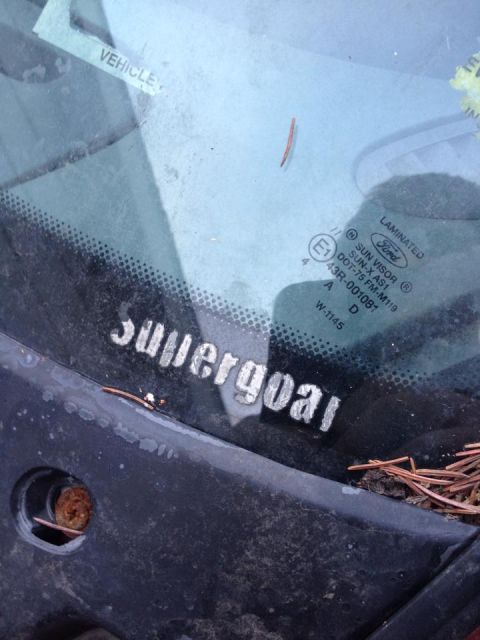 1995 Ford Probe - A close-up view of a windshield with a sticker that reads "Supergoal" in silver lettering. The windshield also has a "Ford" logo and other…