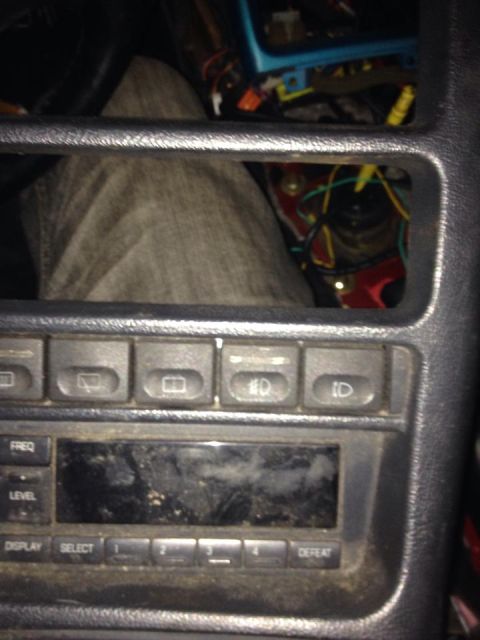 1995 Ford Probe - A close-up view of a car's center console shows a dusty radio display and several buttons. The buttons above the radio appear to control li…
