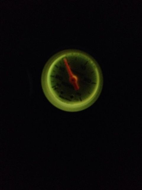 1995 Ford Probe - A close-up shot of a glowing green gauge with a red needle pointing to approximately 30.