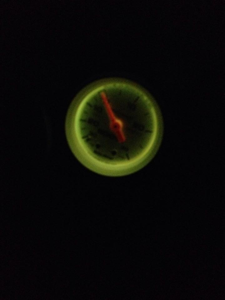 Glowing green gauge with red needle