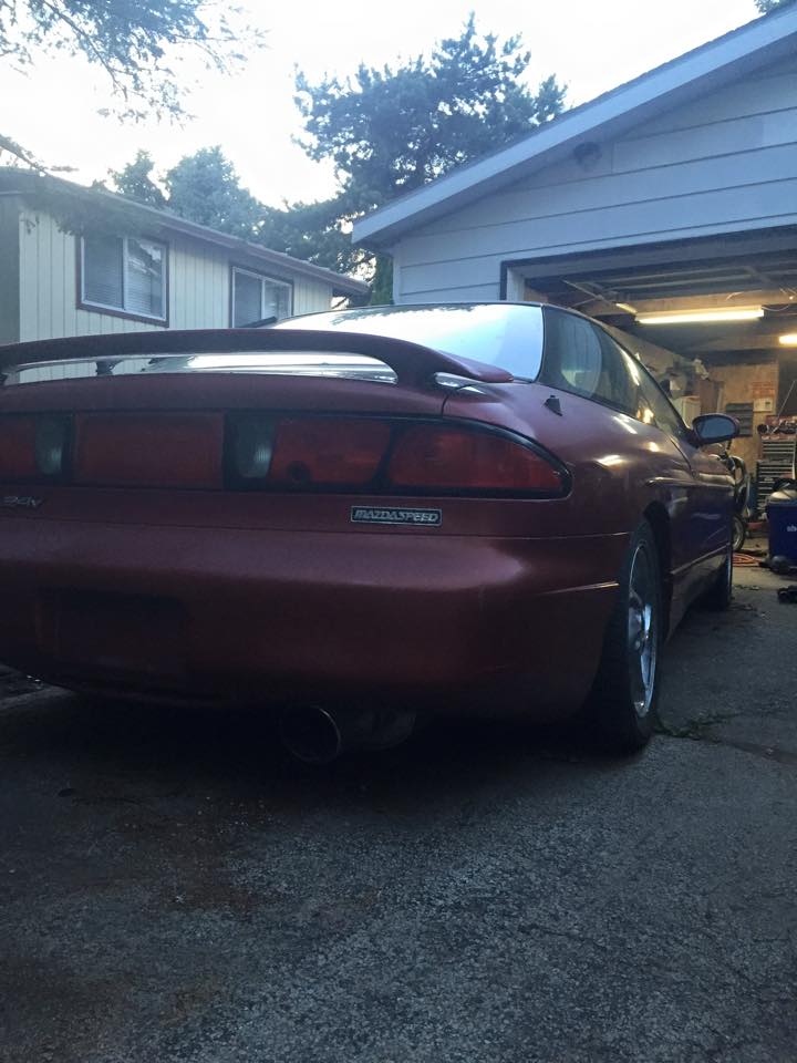 Red MazdaSpeed coupe rear driver's side quarter view
