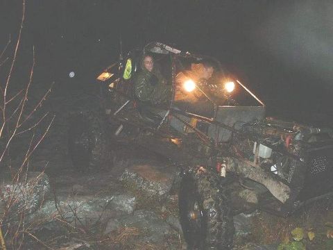 1978 Ford Bronco - Two people are in a modified off-road buggy at night, navigating rocky terrain.