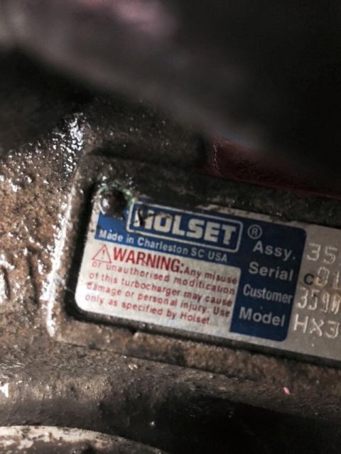 1995 Ford Probe - A close-up view of a metal plate with text, including "HOLSET" and "Made in Charleston SC USA". The plate also contains a warning about mis…