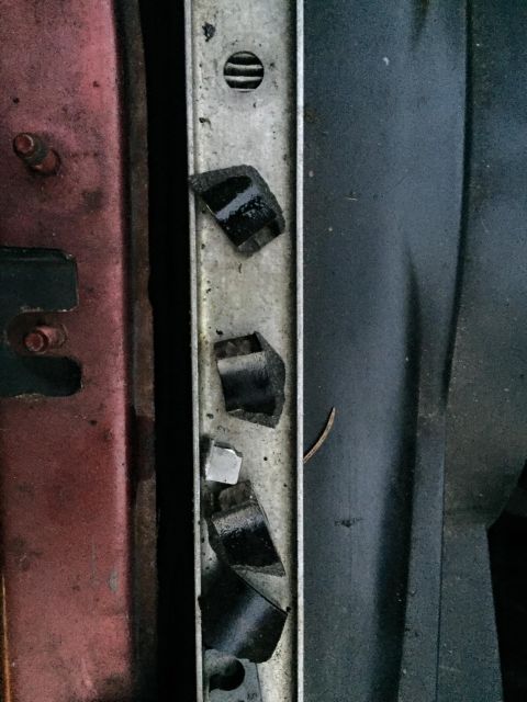 1995 Ford Probe - Detail of a vehicle's front end structure, showing a metal support beam with damaged mounting points.