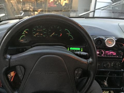 1995 Ford Probe - Interior view of a car's dashboard, a steering wheel with 'PROBE' embossed on it and an aftermarket stereo system.