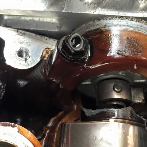 1995 Ford Probe - Close-up view of an engine's oil pump assembly, showing a bolt and gasket detail.