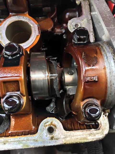 1995 Ford Probe - Damaged engine valve train components are visible in this close-up view, coated in oil.