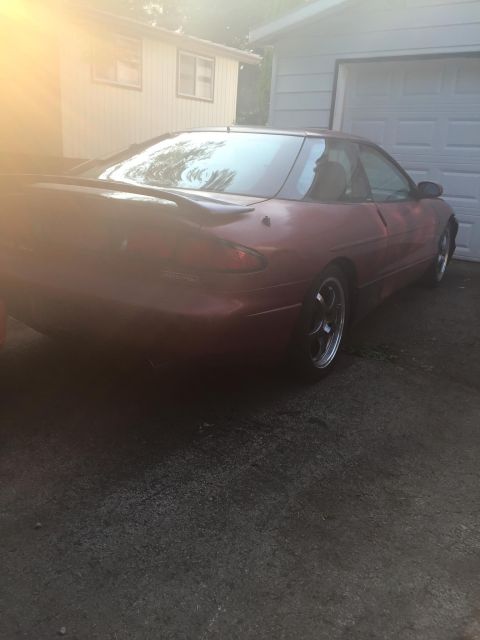 1995 Ford Probe - Rear view of a red 1995 Ford Probe parked in a driveway.