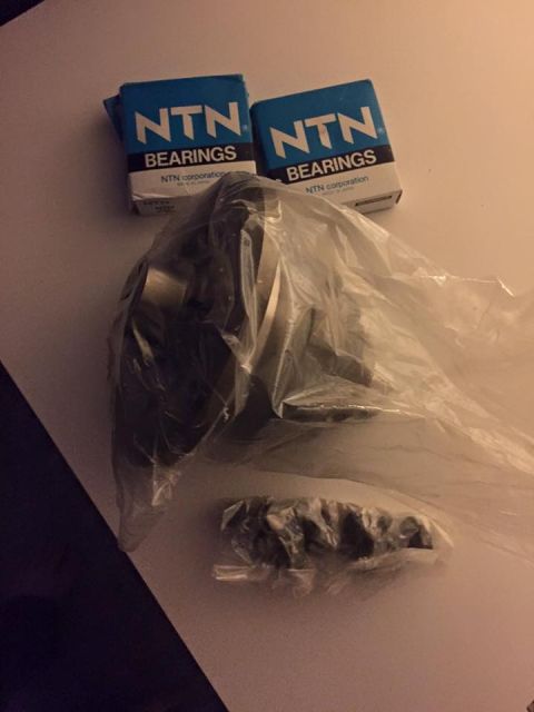 1995 Ford Probe - Two boxes of NTN bearings and a plastic-wrapped automotive part are visible on a white surface.