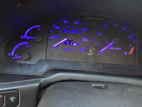 1995 Ford Probe - Dashboard gauges of a 1995 Ford Probe, illuminated in blue, display mileage and RPM.