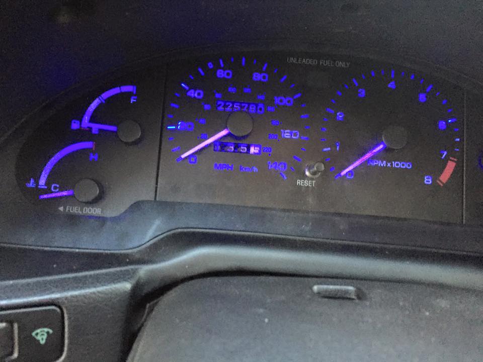 1995 Ford Probe dashboard with blue illuminated gauges showing 225,280 miles and RPM