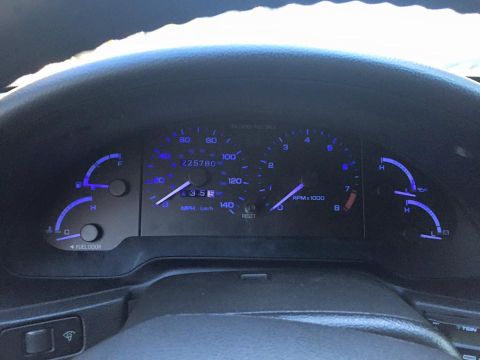 1995 Ford Probe - The interior of a car shows a dashboard with illuminated gauges and a steering wheel.
