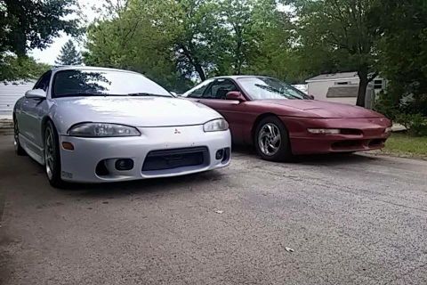 1995 Ford Probe - Two sports cars, a 1995 Ford Probe and a Mitsubishi Eclipse, are parked side-by-side.