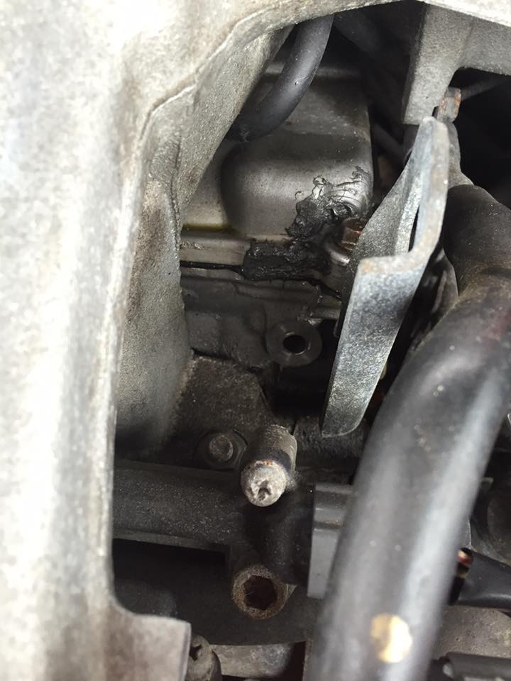 Engine part with black sealant and hose
