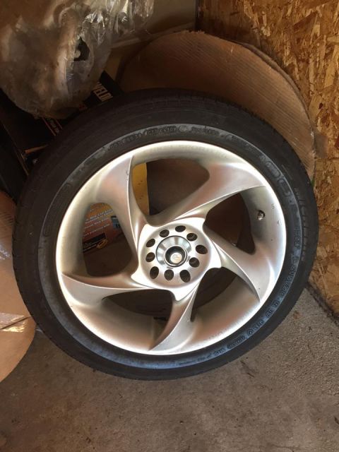 1995 Ford Probe - Aftermarket wheel and tire assembly shown in storage.