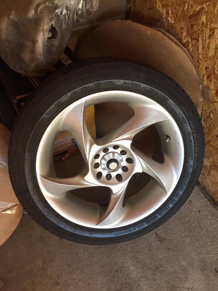 Aftermarket five-spoke alloy wheel with a tire mounted