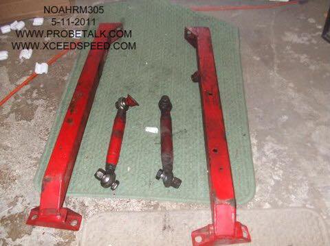 1995 Ford Probe - Red suspension components are laid out on a green mat, with website URLs visible in the background.