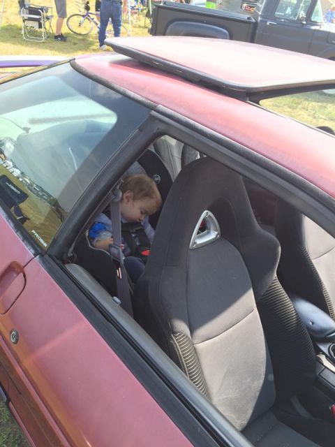 1995 Ford Probe - A child sleeps in a car seat inside a 1995 Ford Probe.