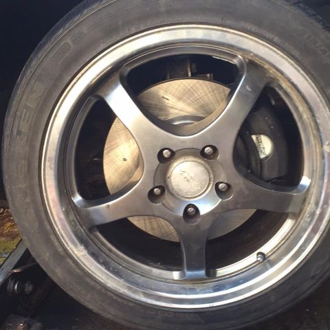 1995 Ford Probe - Close-up of a vehicle's wheel and brake system, with visible tire branding and a watermark at the bottom.