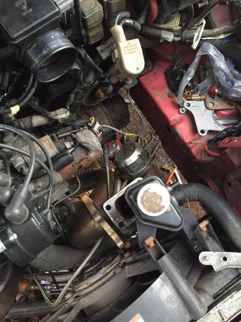 1995 Ford Probe - Close-up view of a cluttered engine bay with many components and wires visible.