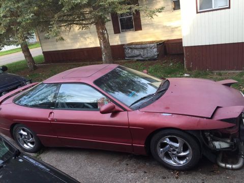 1995 Ford Probe - A maroon Ford Probe with its front end partially disassembled sits in a driveway.