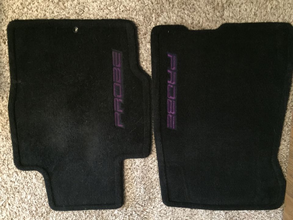 Two black car floor mats with purple "PROBE" text.