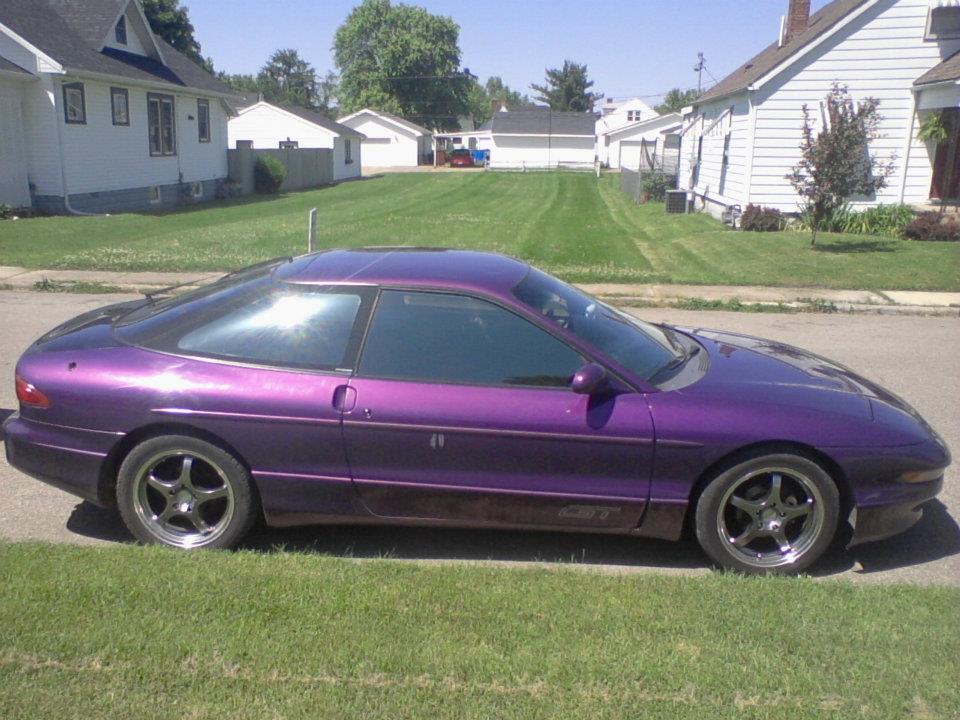 Purple 1995 Ford Probe GT parked on a residential street.