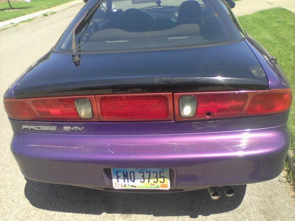 Rear view of a purple Ford Probe with black decklid and custom paint.
