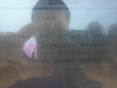 1995 Ford Probe - A close-up of a digital display shows text related to a Ford vehicle, including DTC codes and part names like "Solenoid Valve" and "EGR (Ve…
