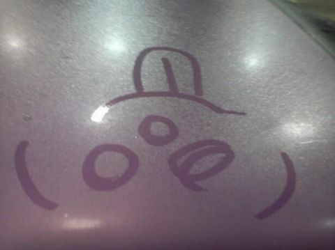 1995 Ford Probe - A simple drawing of a face with a hat is drawn on a purple surface. The drawing includes two circles for eyes, a smaller circle for a nose,…