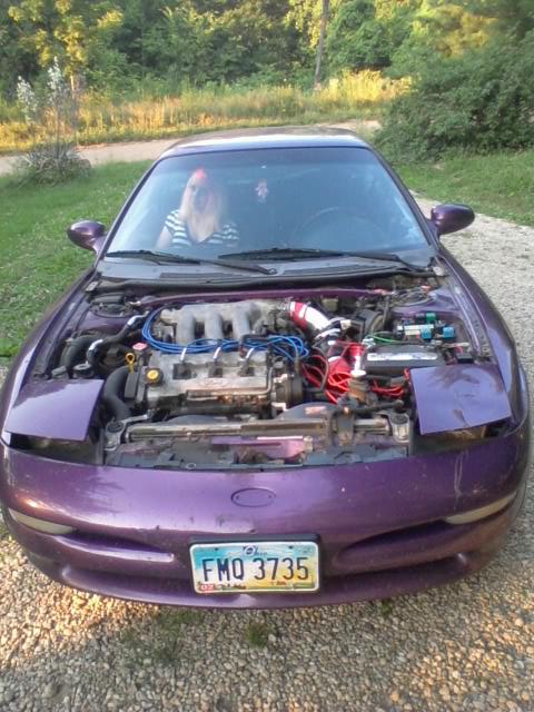 1995 Ford Probe - Front view of a purple 1995 Ford Probe with the hood open, revealing the engine bay. The license plate reads FMO 3735.