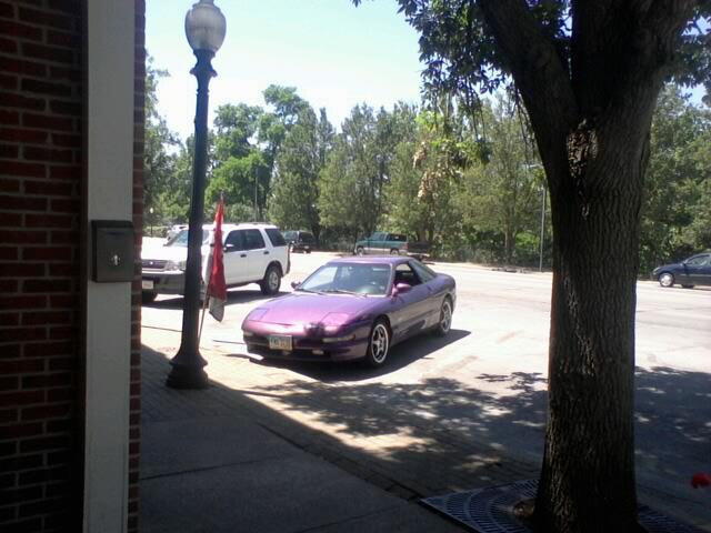 Purple 1995 Ford Probe parked on a lot with a white SUV behind it.