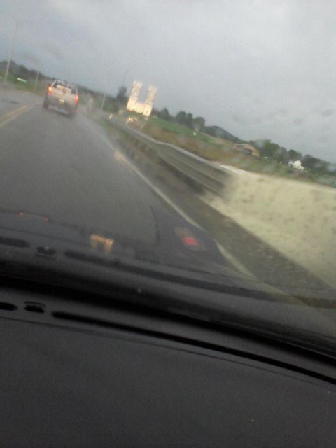 1995 Ford Probe - A blurry view from inside a vehicle looking out at a wet road with a pickup truck ahead. The sky is overcast.