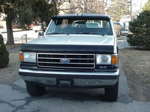 1993 Ford Bronco - This 1993 Ford Bronco is shown from the front, a black bug deflector and a black sun visor.