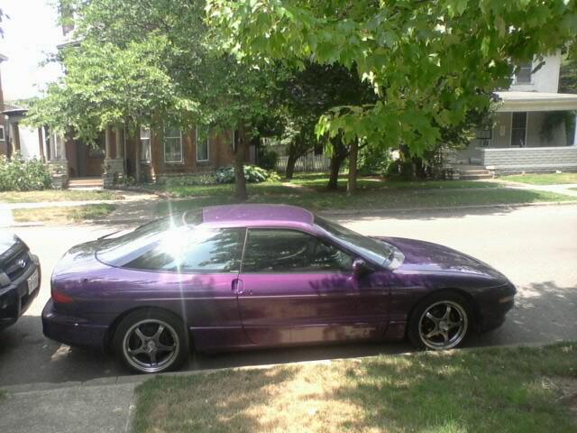 Purple 1995 Ford Probe parked curbside, side view