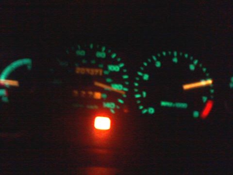 1995 Ford Probe - The illuminated dashboard gauges show a digital odometer reading of 207371.