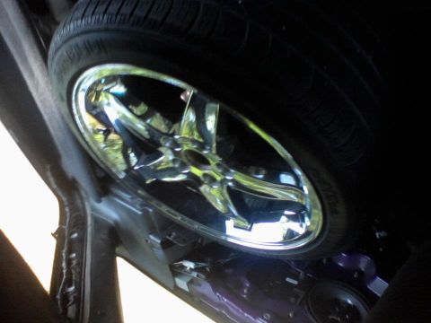 1995 Ford Probe - Spare tire and wheel assembly visible inside the wheel well of a vehicle.