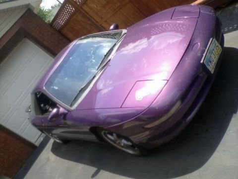 1995 Ford Probe - A purple car is parked in a driveway with a garage door in the background. The license plate is visible.
