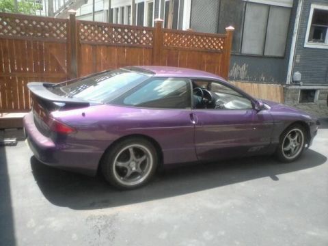 1995 Ford Probe - Side profile of a purple 1995 Ford Probe GT with a rear spoiler.
