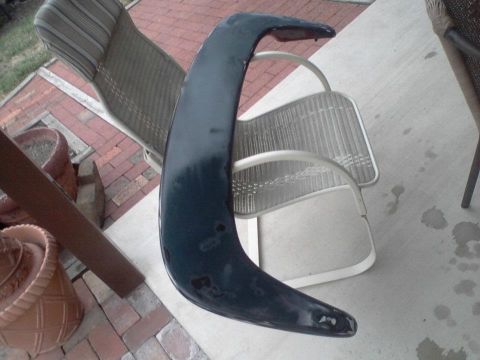 1995 Ford Probe - A dark blue car spoiler is shown resting on outdoor patio chairs.