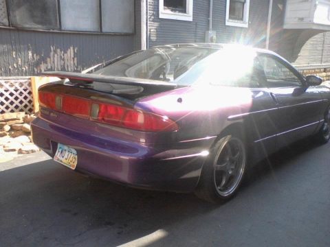1995 Ford Probe - The rear view of a purple 1995 Ford Probe shows its taillights and spoiler.